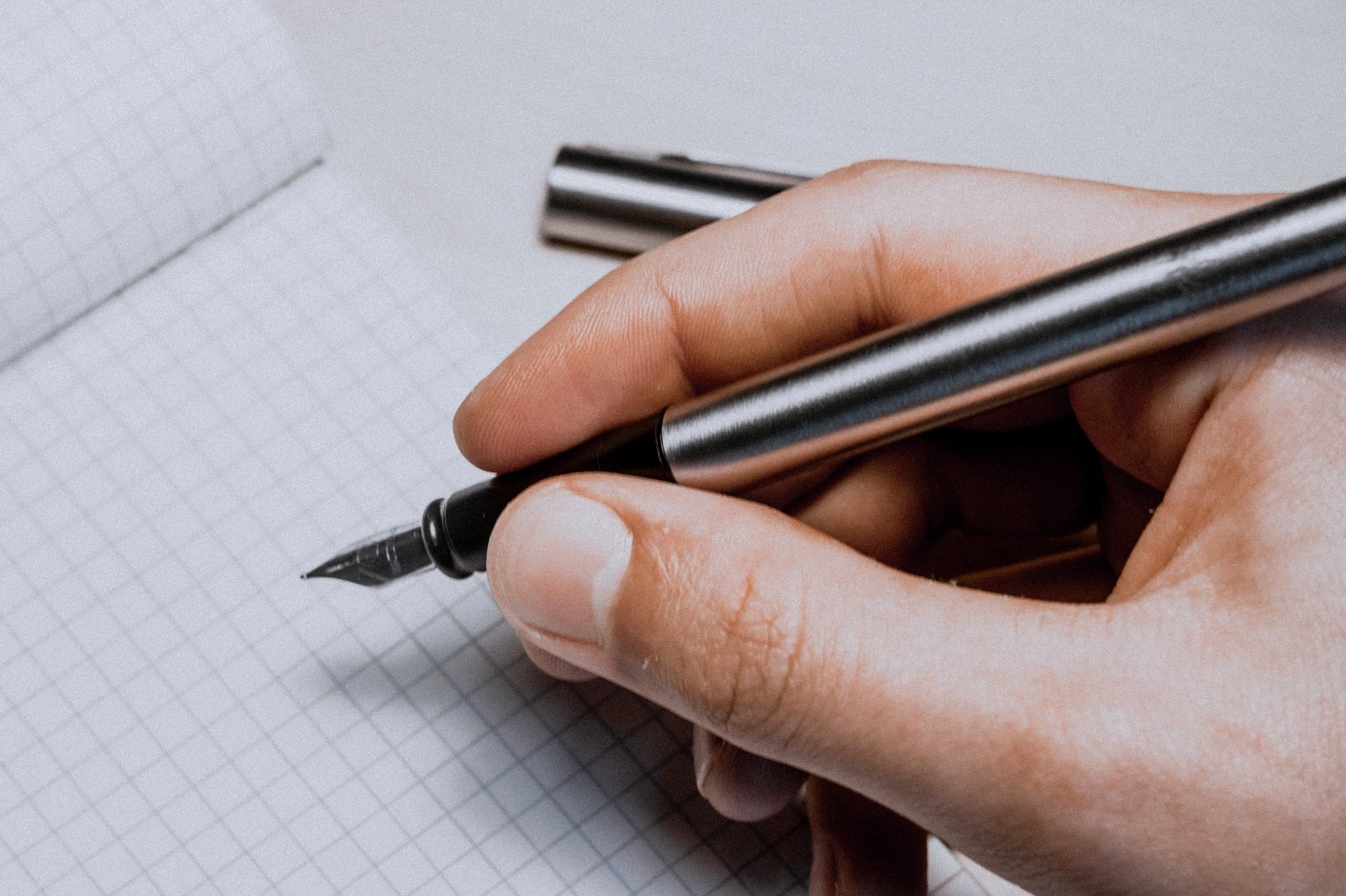 A hand writing with a fountain pen
