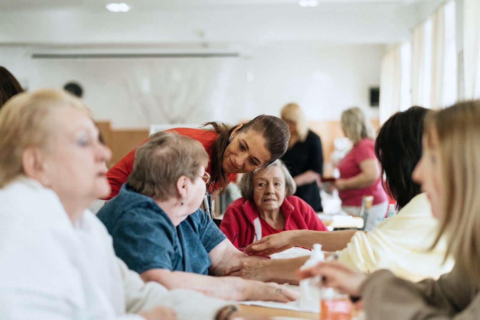 A group of older people in discussion around a table